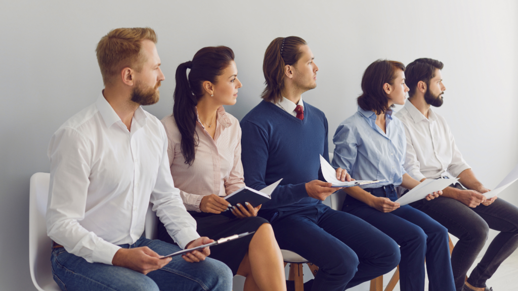 Applicants sitting in a row waiting for a job interview