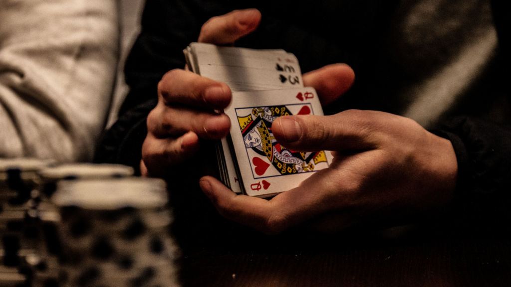 a person holding a playing cards