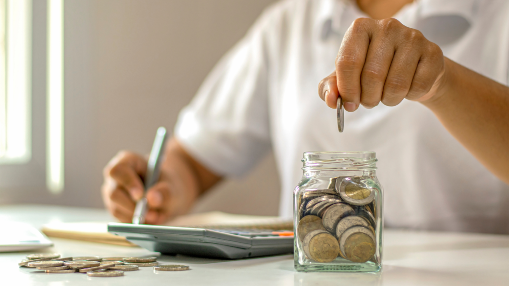 a person putting coins in a jar