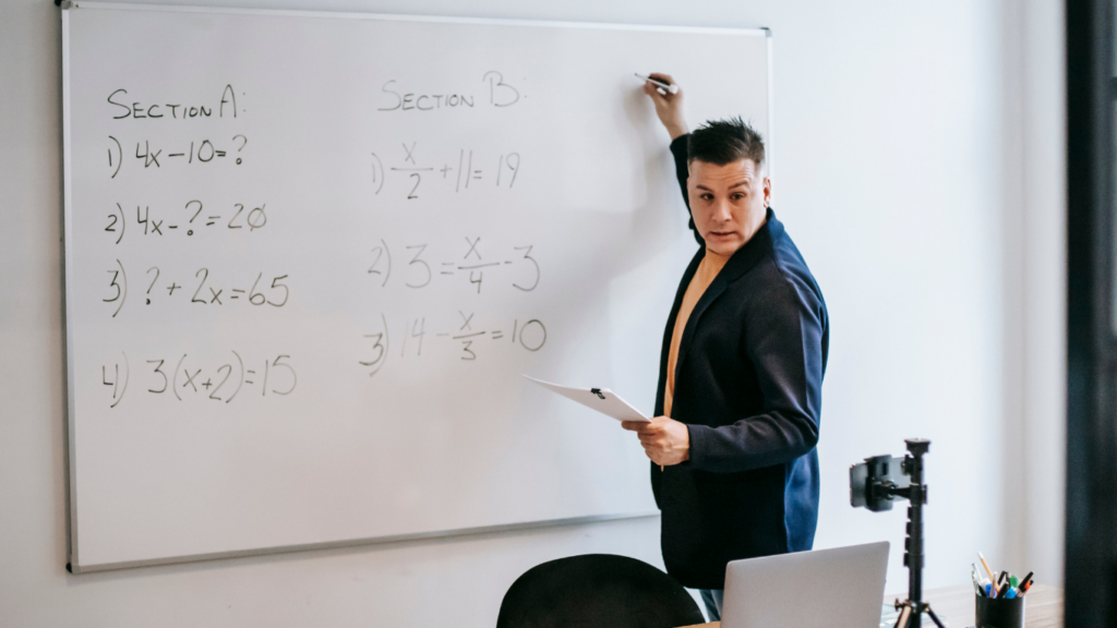 a person writing in whiteboard