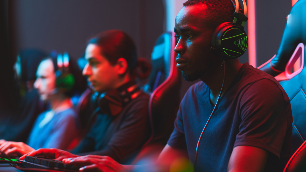 a group of people playing video games in a dark room