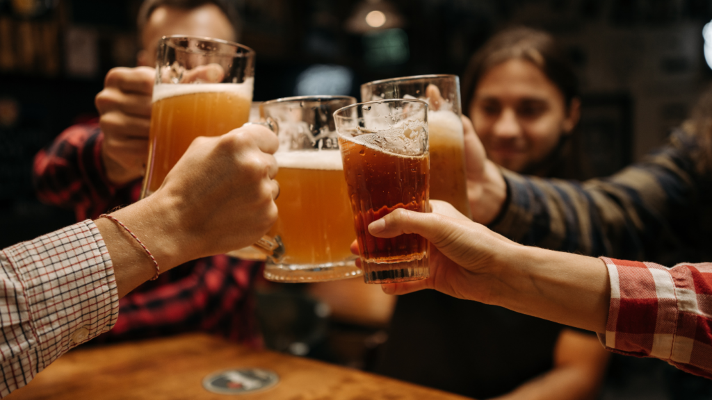 a group of people toasting with drinks at a party