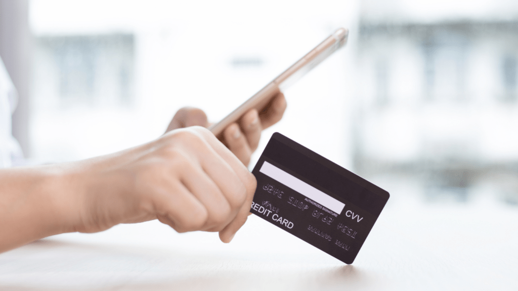 a person holding a credit card