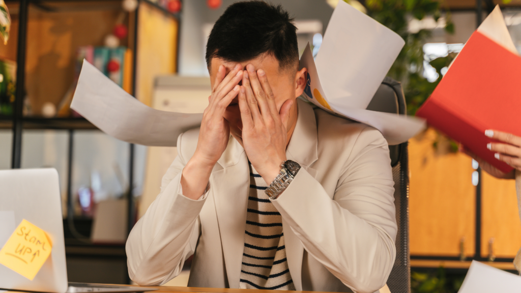 a person sitting on a couch with their head in their hands